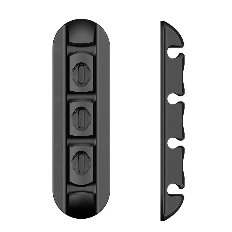 Black soft plastic desktop organiser holding a magnetic charging cable in place.