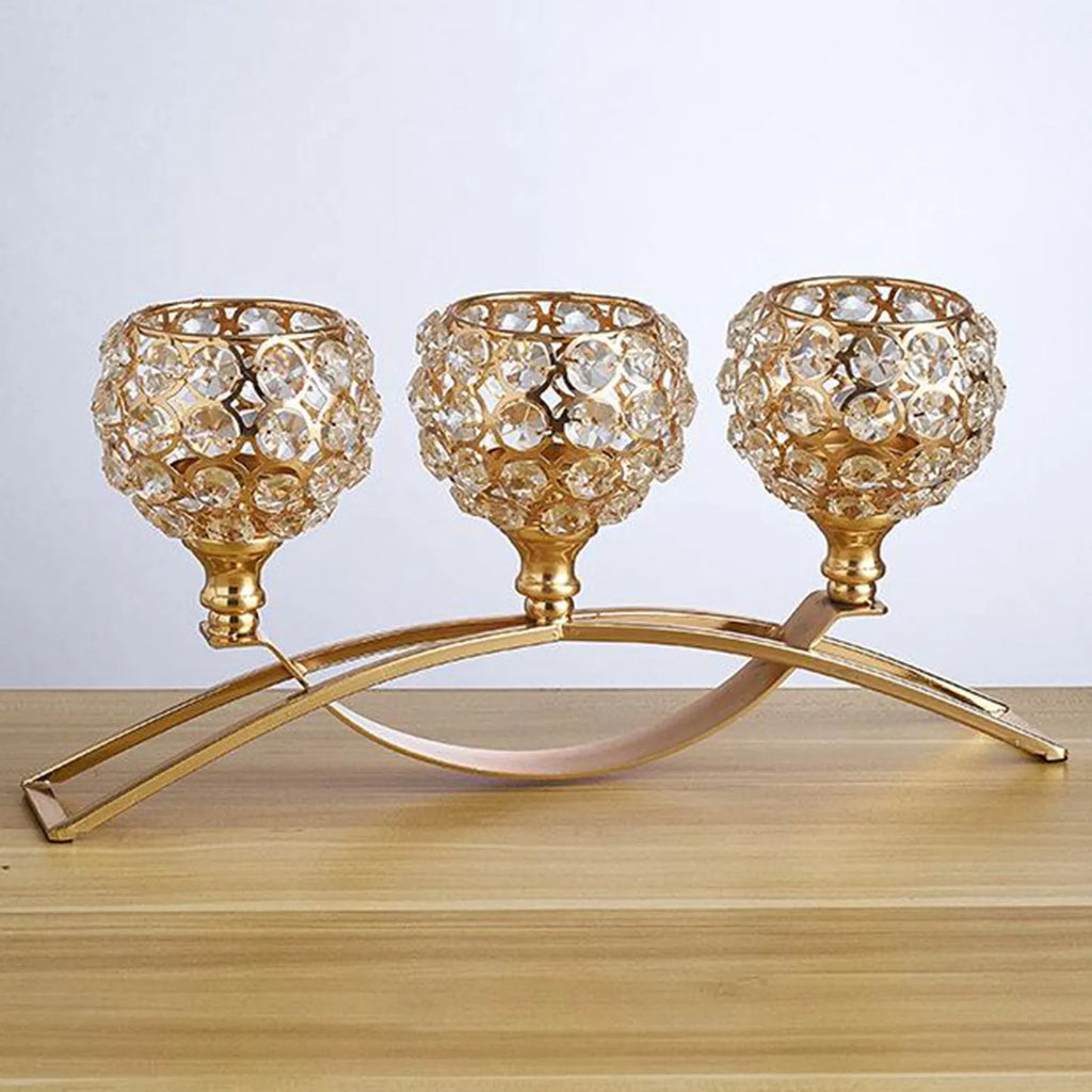Geometric crystal candle holder with gold electroplated wrought iron frame on a table