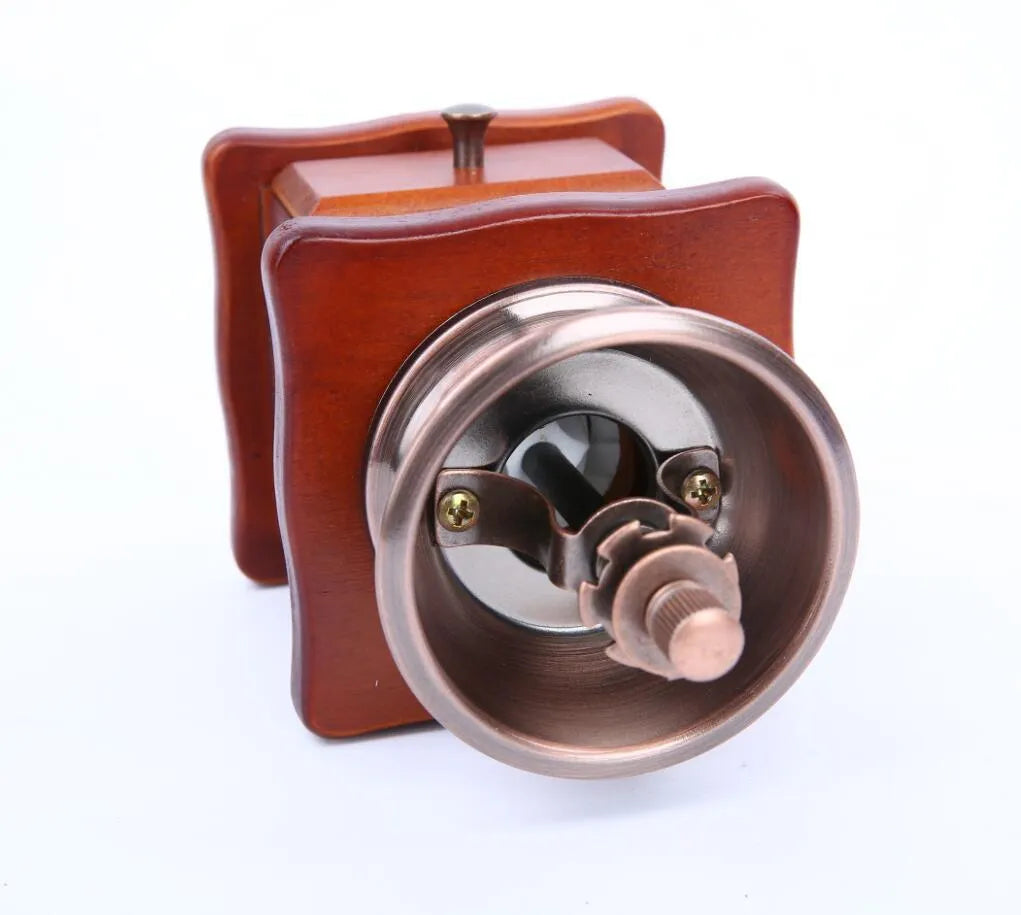 Red manual coffee grinder with pine wood, cast iron and ceramic parts, 10x10x17cm, for 2-3 servings.