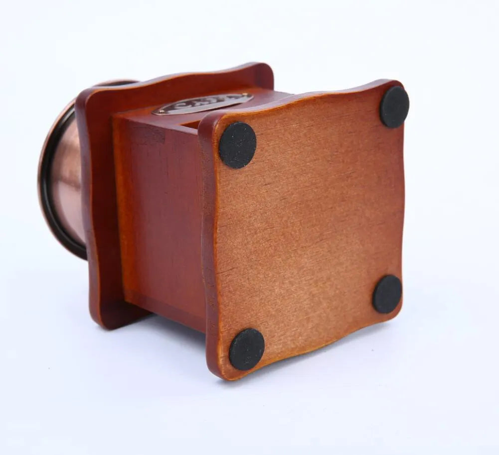 Red manual coffee grinder with pine wood, cast iron and ceramic parts, 10x10x17cm, for 2-3 servings.