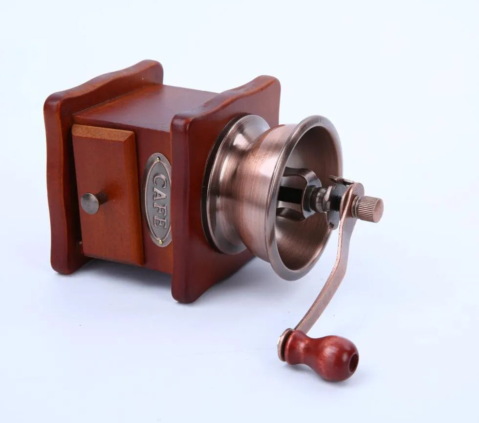 Red manual coffee grinder with pine wood, cast iron and ceramic parts, 10x10x17cm, for 2-3 servings.