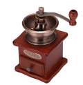 Red manual coffee grinder with pine wood, cast iron and ceramic parts, 10x10x17cm, for 2-3 servings.
