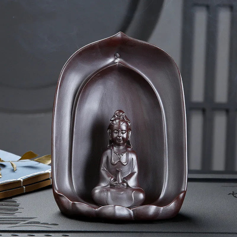 Handmade ceramic Guanyin Sitting Lotus statue with integrated back flow incense burner on a wooden table.