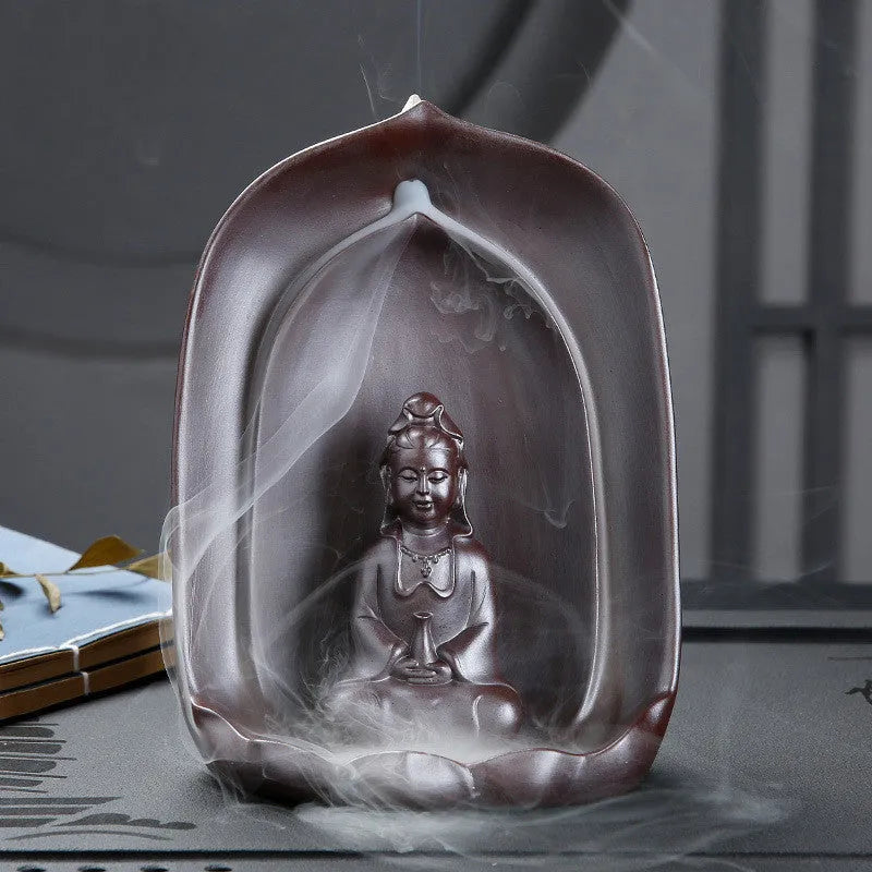 Handmade ceramic Guanyin Sitting Lotus statue with integrated back flow incense burner on a wooden table.