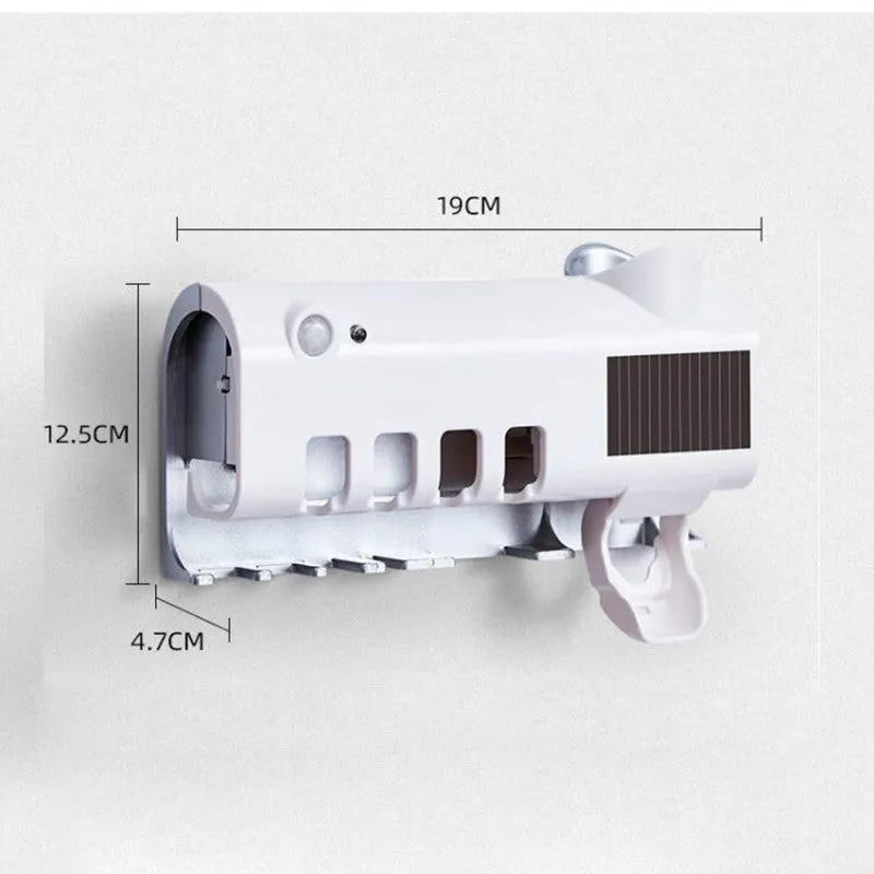 Black wall-mounted UV toothbrush steriliser with automatic toothpaste squeezer on bathroom tiles