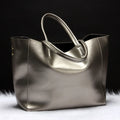Women's leather shoulder bag in bronze colour with adjustable strap showing interior lining