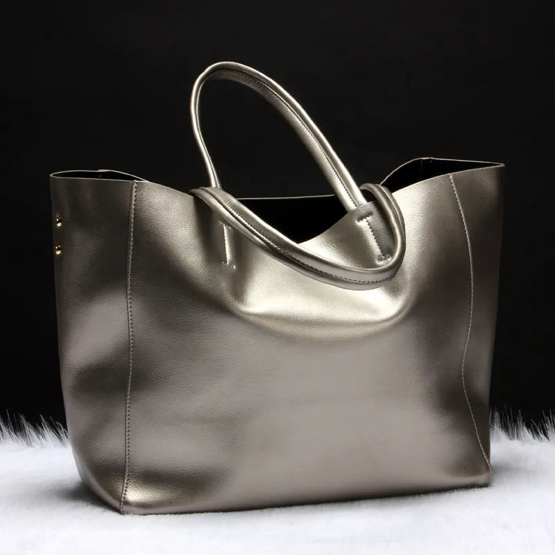 Women's leather shoulder bag in bronze colour with adjustable strap showing interior lining