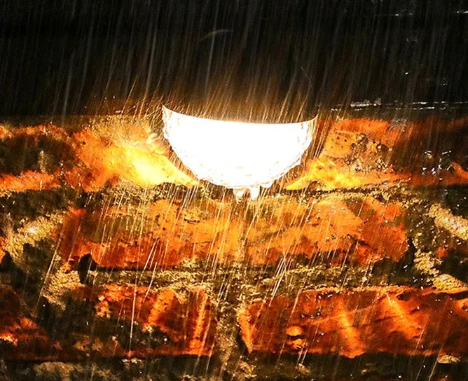 Solar wall light with water drop design, casting light and shadow at night, IP55 waterproof