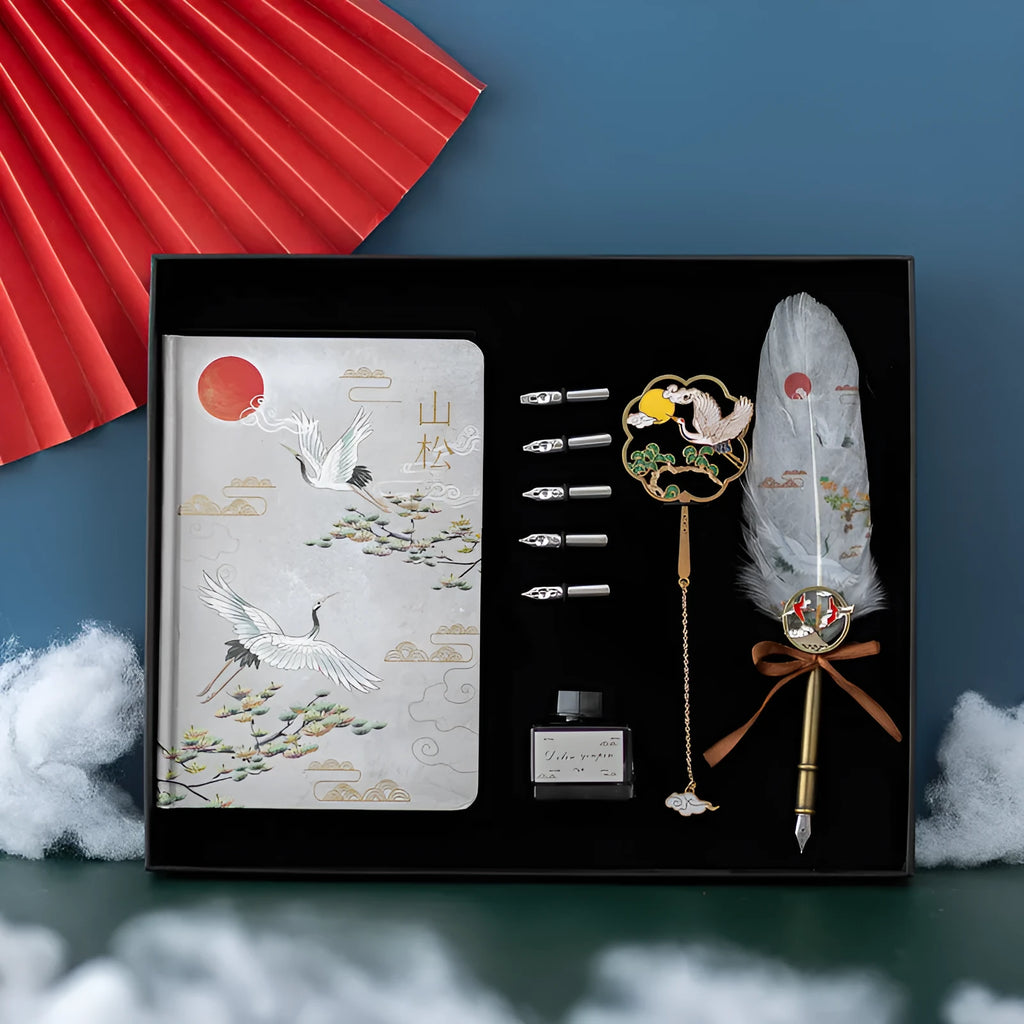 Chinese style metal case open to show feather pens in four colour assortments with a notebook and pen sheath.