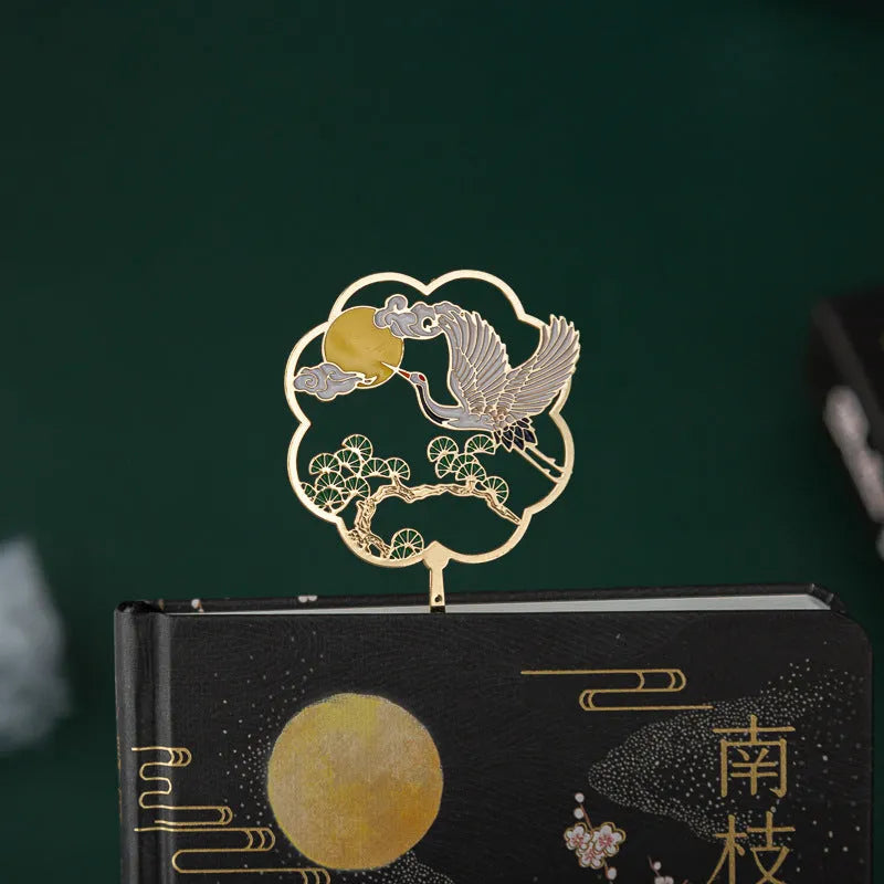 Chinese style metal case open to show feather pens in four colour assortments with a notebook and pen sheath.