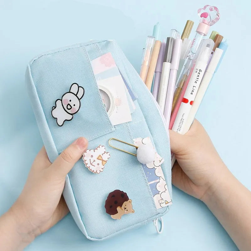 Canvas pencil case for women in Japanese Harajuku style with three random badges, shown in matcha green, jade blue, licorice powder or purple.