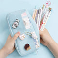 Canvas pencil case for women in Japanese Harajuku style with three random badges, shown in matcha green, jade blue, licorice powder or purple.