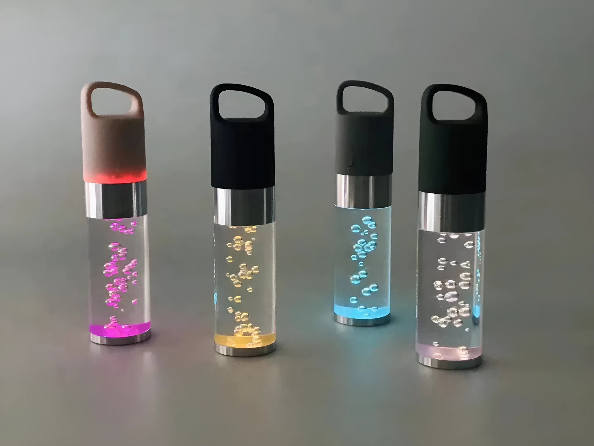 Colourful portable Bluetooth speaker with crystal light feature in pink, black, silver grey, or green.