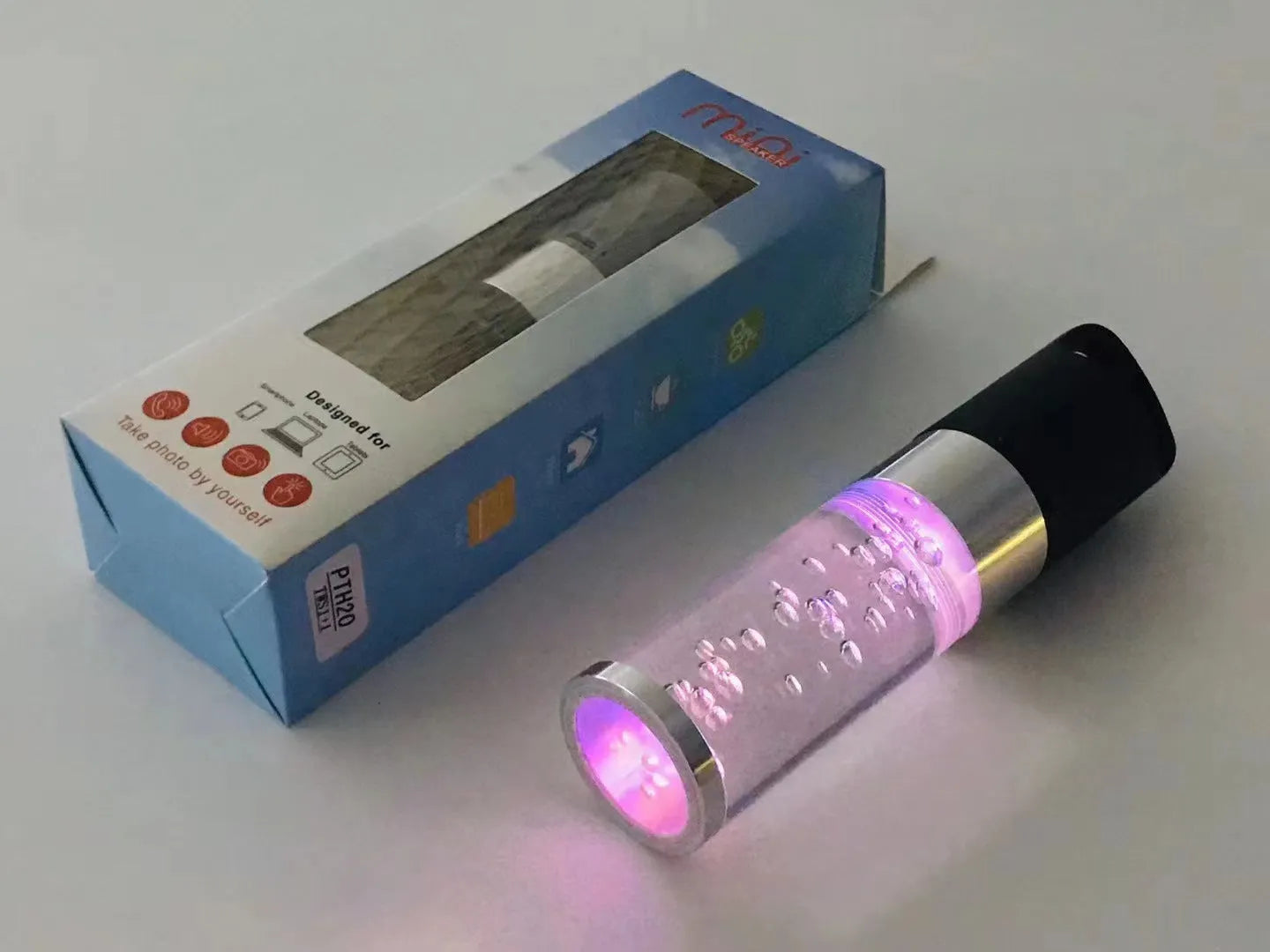 Colourful portable Bluetooth speaker with crystal light feature in pink, black, silver grey, or green.