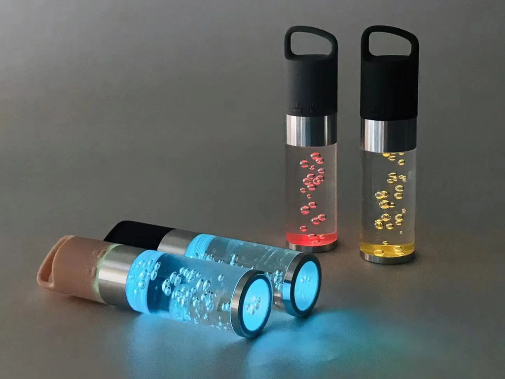 Colourful portable Bluetooth speaker with crystal light feature in pink, black, silver grey, or green.