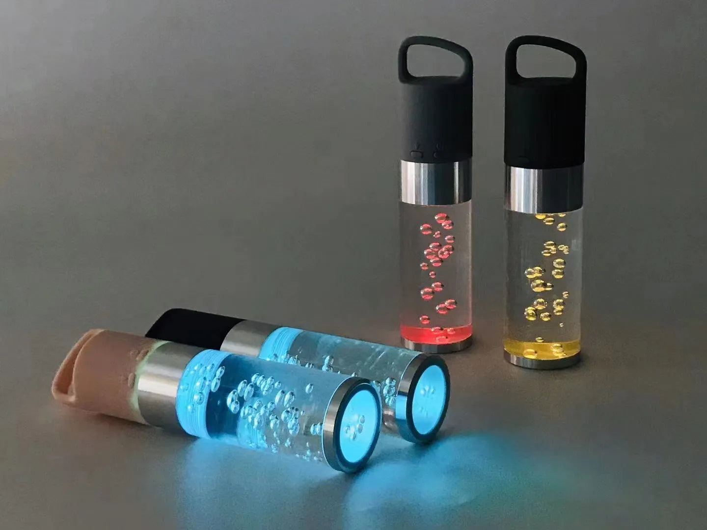 Colourful portable Bluetooth speaker with crystal light feature in pink, black, silver grey, or green.