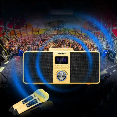 Black and gold home KTV Bluetooth speaker with two wireless microphones on a table.