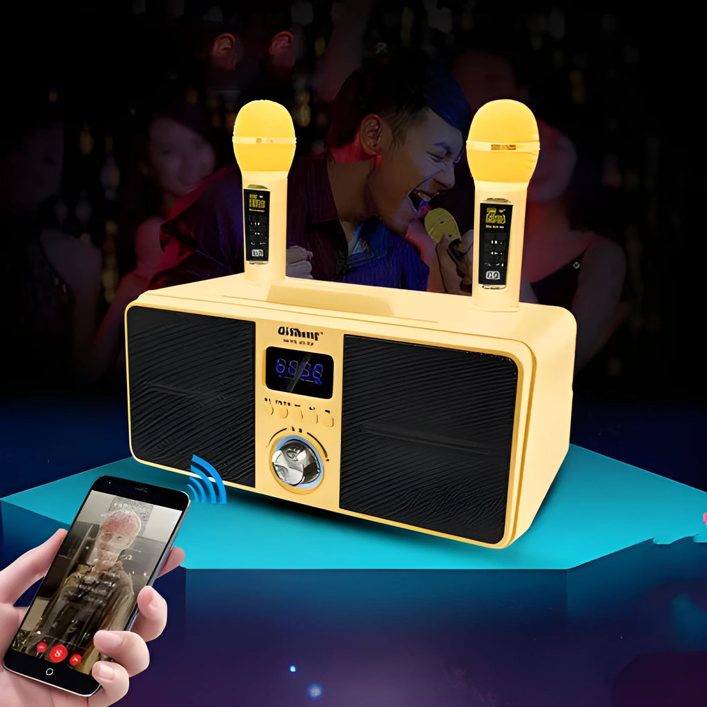 Black and gold home KTV Bluetooth speaker with two wireless microphones on a table.