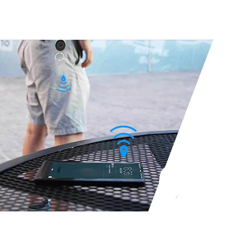 Black ABS plastic Bluetooth anti-lost tracker keychain with metal loop, shown with phone and keys.