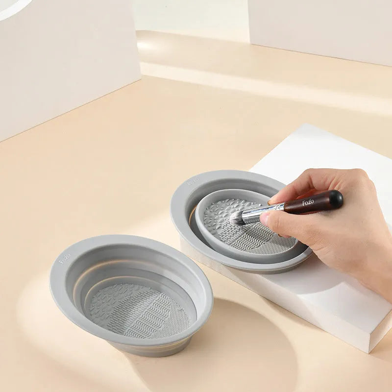 Silicone foldable makeup brush cleaning bowl with textured scrubbing plate in pastel pink