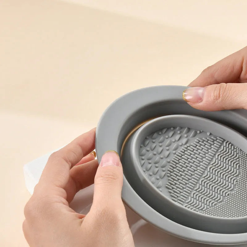 Silicone foldable makeup brush cleaning bowl with textured scrubbing plate in pastel pink