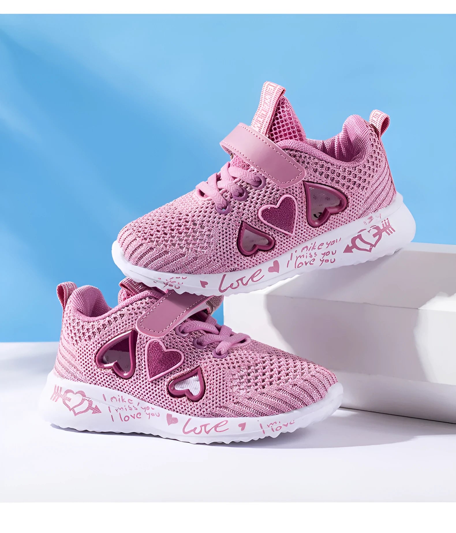Pair of pink children's velcro sneakers with mesh upper and hand-painted pattern on a white background.