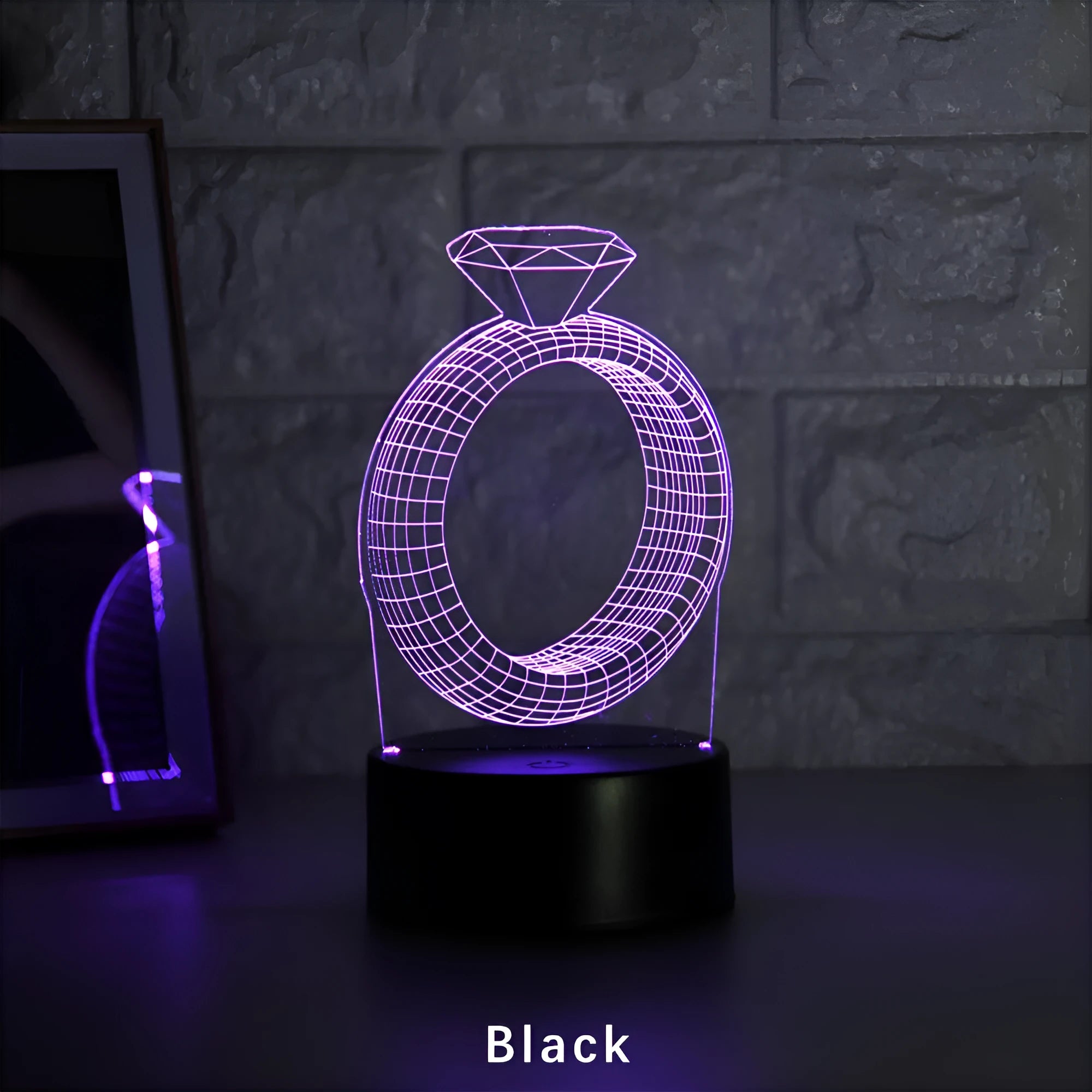 3D LED night light showing holographic diamond ring with colour-changing glow on a black base.