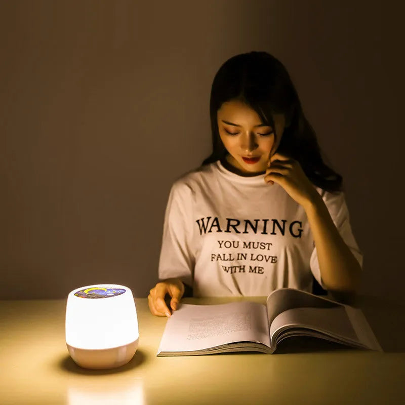 Pruixin rotating star projector night light projecting galaxy patterns on a bedroom ceiling.