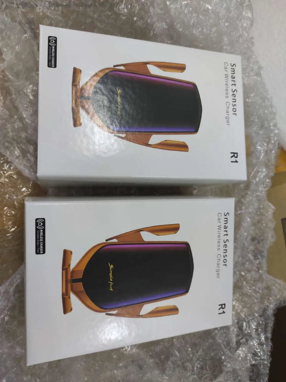Magic Clip R1 wireless charging car phone holder in gold mounted on a car dashboard.