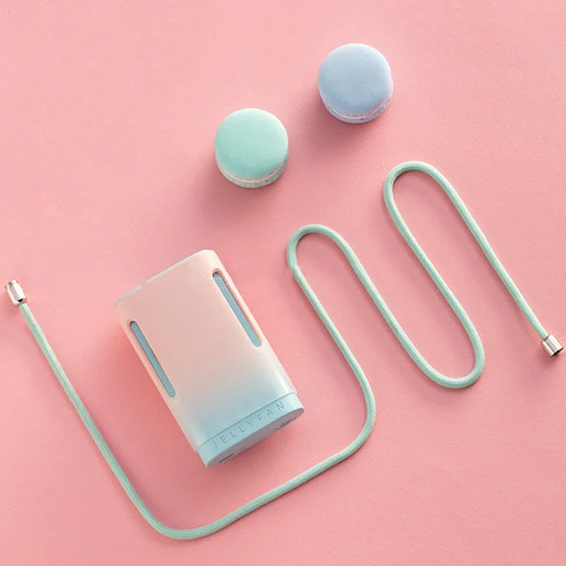 USB rechargeable jelly hanging neck fan in mint peach colour showing handheld and neck-worn modes.