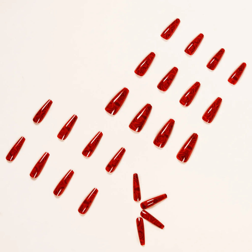Pack of 24 wine red rose wearing nail art finished product tablets with glue on a manicure table
