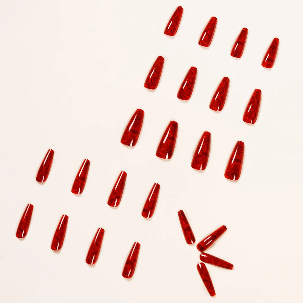 Pack of 24 wine red rose wearing nail art finished product tablets with glue on a manicure table