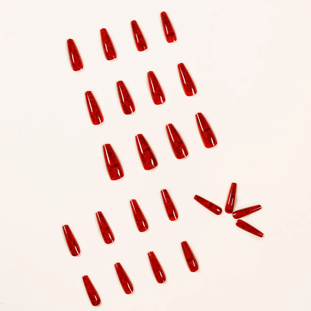 Pack of 24 wine red rose wearing nail art finished product tablets with glue on a manicure table
