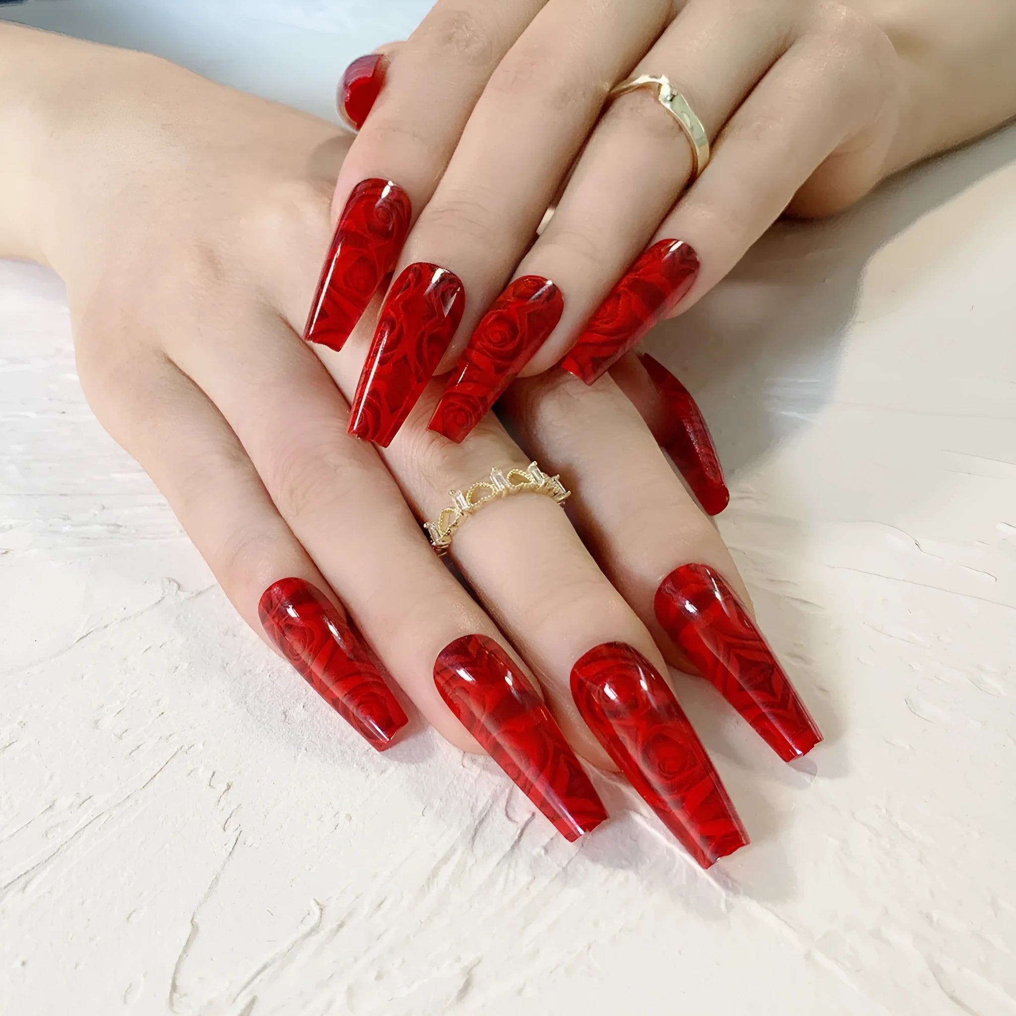 Pack of 24 wine red rose wearing nail art finished product tablets with glue on a manicure table