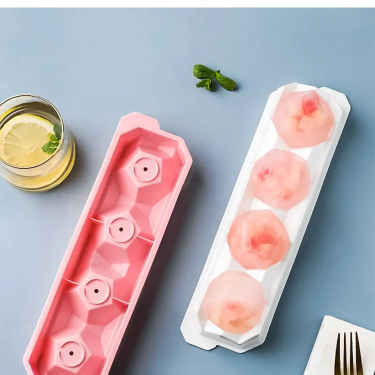Flexible silicone ice tray making large hockey puck, round, and pentagon shaped ice cubes in assorted colours.