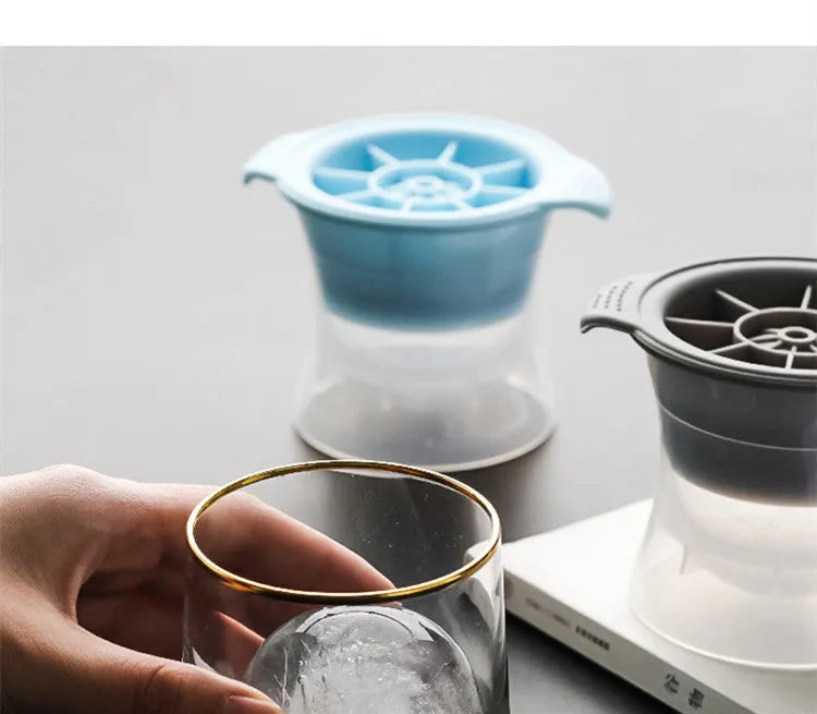 Flexible silicone ice tray making large hockey puck, round, and pentagon shaped ice cubes in assorted colours.
