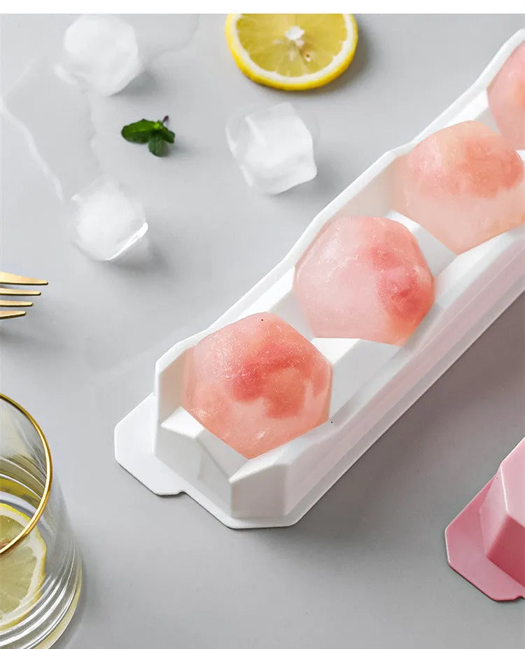 Flexible silicone ice tray making large hockey puck, round, and pentagon shaped ice cubes in assorted colours.