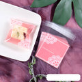 Pink self-adhesive plastic bag with resealable flap for packaging handmade soap, shown sealed.