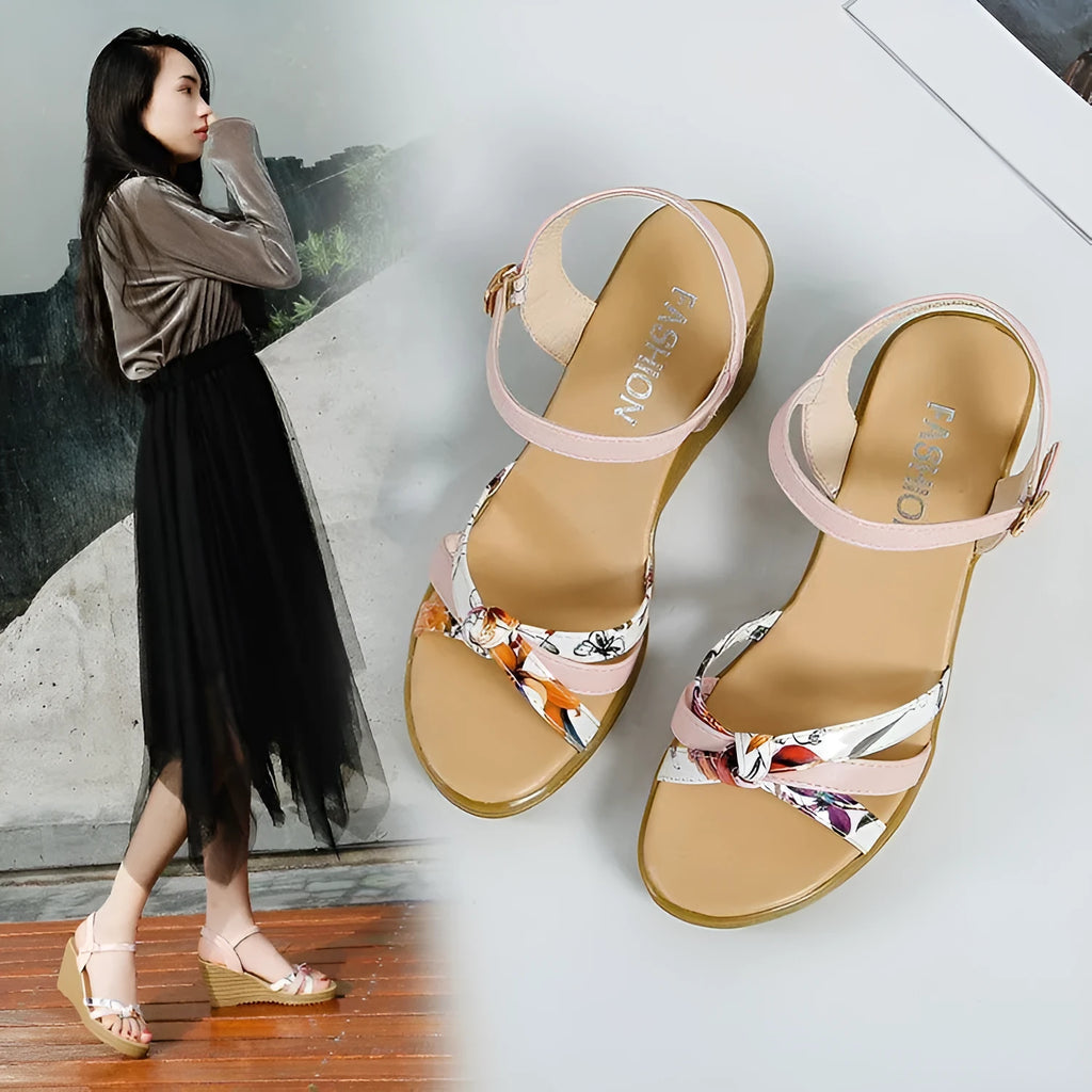 Pink women's wedge heel sandals with an adjustable buckle on a white background, showing the non-slip sole pattern.