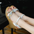 Pink women's wedge heel sandals with an adjustable buckle on a white background, showing the non-slip sole pattern.