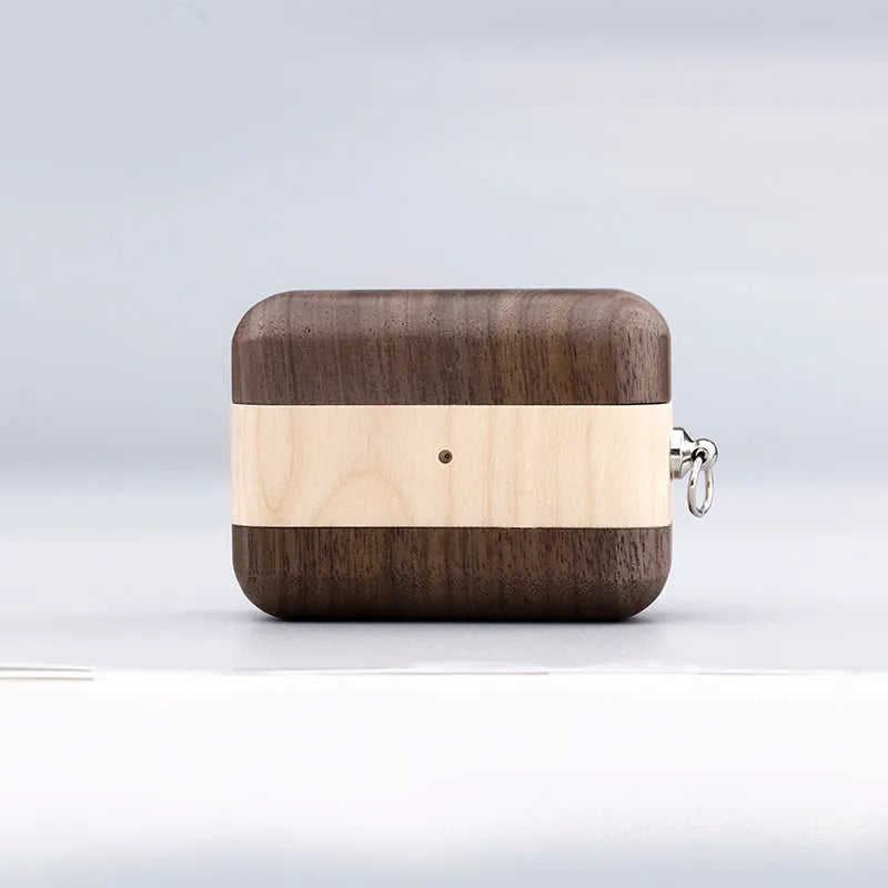 LZL solid wood earphone sleeve in walnut with attached lanyard, next to wireless earphones.