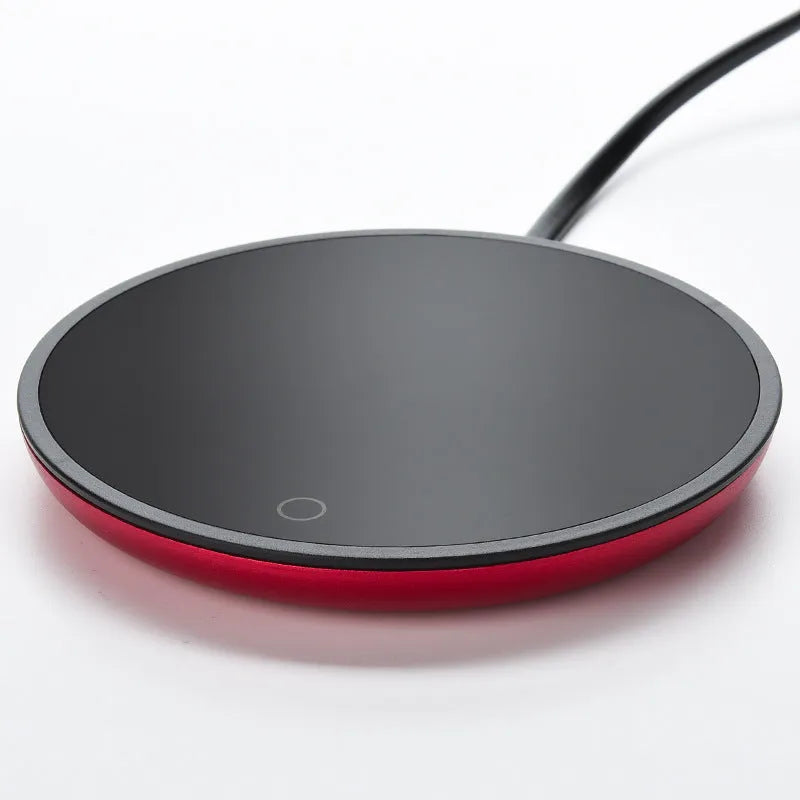 Electric constant temperature cup warmer pad in red colour on a desk with a coffee cup