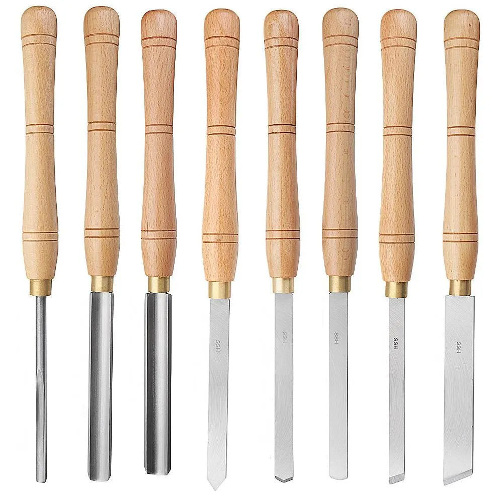 Open wooden case displaying eight different steel woodturning tools: gouges, chisels, and scrapers for lathe work.