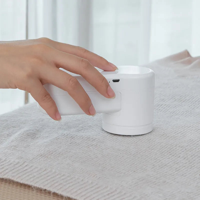 White portable electric lint remover trimmer with ABS body, shown in rechargeable and dry battery styles for fabric shaving.