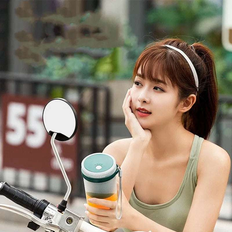 Portable pink electric juicer cup with USB charging port and pulp collection box