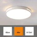 Round modern acrylic LED ceiling lamp with remote control on a white ceiling.