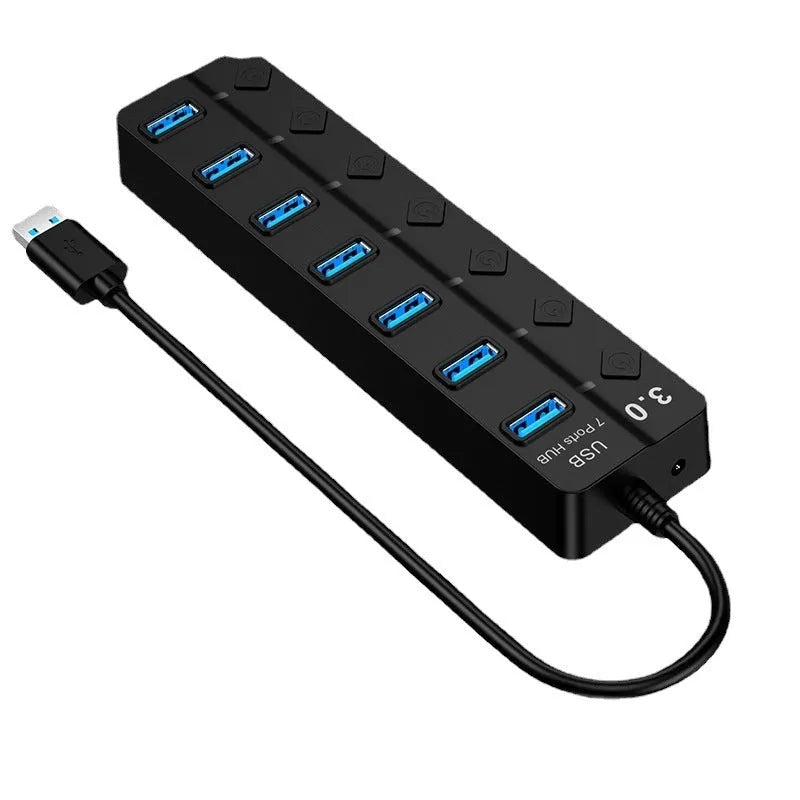 Black 7-port USB 3.0 hub with external power adapter and cable on a desk