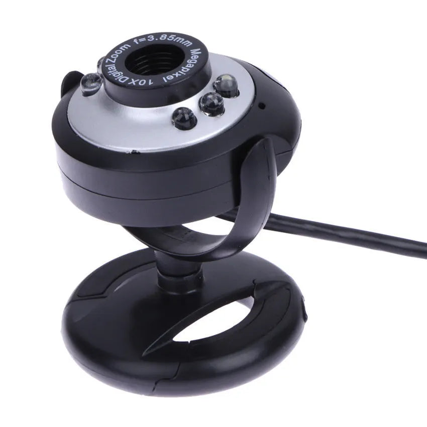 A black computer webcam with a ring of six LED lights around the lens, shown on a desktop.