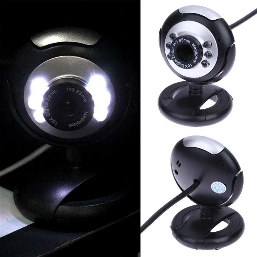 A black computer webcam with a ring of six LED lights around the lens, shown on a desktop.