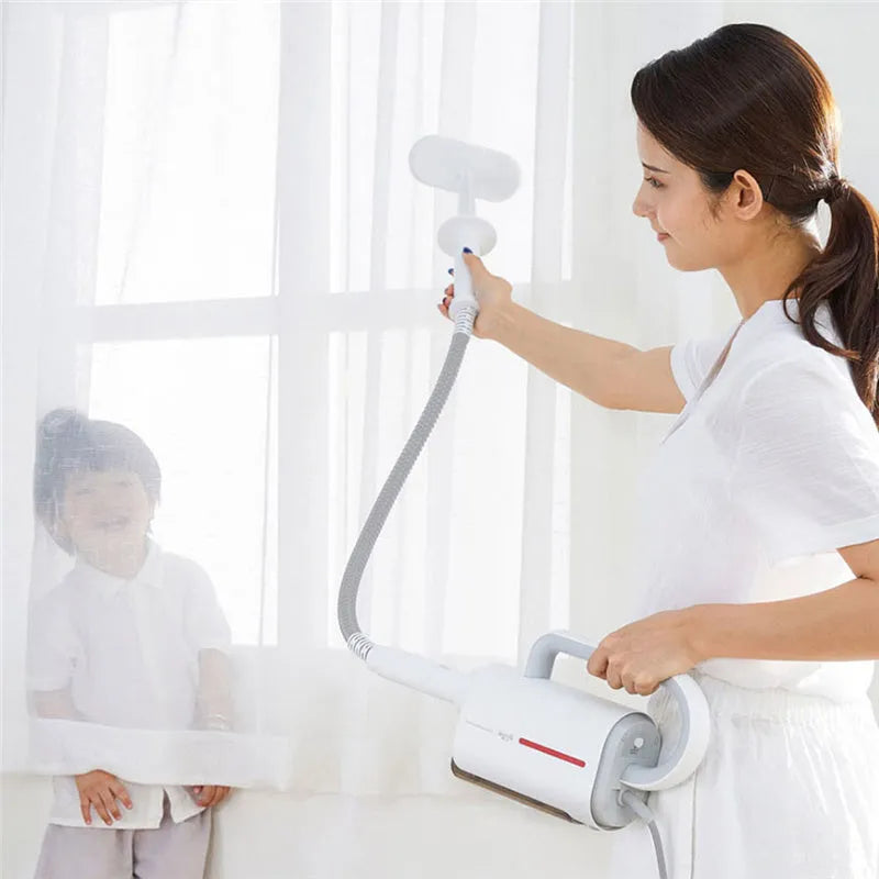 White Deerma ZQ610 steam cleaner main unit with five brush heads and connecting tubes laid out.
